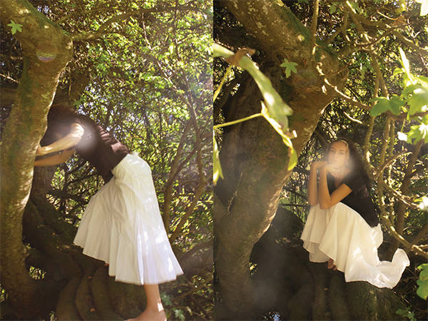 woman climbing into a tree and then sitting down in it