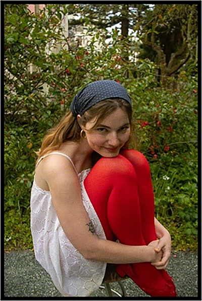 chloe sitting on a stool outside